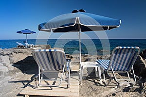 Sunshade and sun beds on Kalithea beach, Rhodes photo