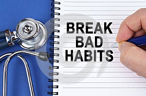 On a blue surface lies a stethoscope and a notebook in which it is written by hand - Break Bad Habits