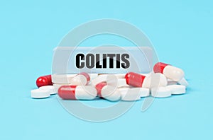 On the blue surface of the pills, capsules and a plate with the inscription - COLITIS