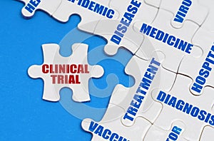 On the blue surface, puzzles with medical inscriptions, on a separate puzzle it is written - CLINICAL TRIAL