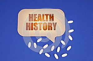 On the blue surface of the tablet and a cardboard plate with the inscription - HEALTH HISTORY
