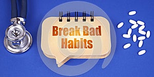 On the blue surface of the tablet, a stethoscope and a notepad with the inscription - Break Bad Habits