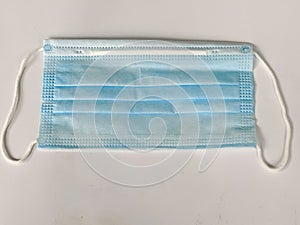 Blue Surgical Face Mask Sitting On White Background
