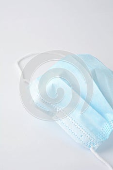 Blue surgical face mask on white background