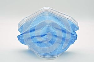 Blue surgical mask, isolated on white background photo