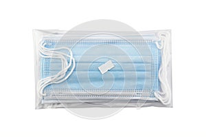 blue surgical mask or medical face mask in transparent plastic packaging with price tag isolated on white background