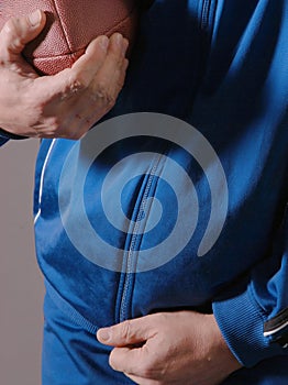 Blue sweats holding football
