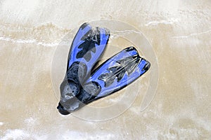 Blue swim fins on the beach