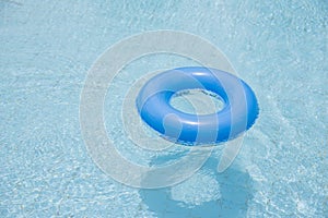 blue swim ring float on swimming pool isolated