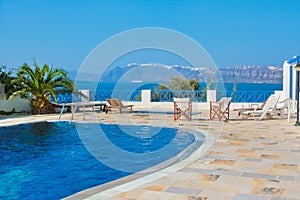 Blue swimming pool in Fira, Santorini, Greece.