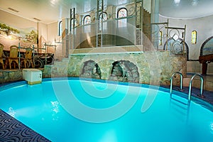 Blue swimming pool in modern spa interior