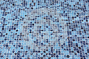 Blue swimming pool with ripple water