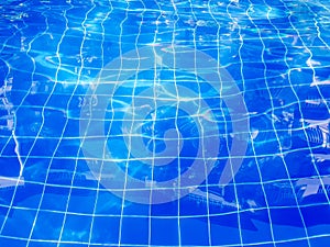 Blue swimming pool rippled water background