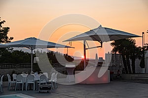 Blue swimming pool in a spa hotel in southern Italy at sunset