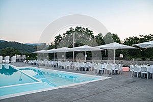 Blue swimming pool in a spa hotel in southern Italy at sunset