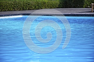 Blue swimming pool summer vacation and wooden deck