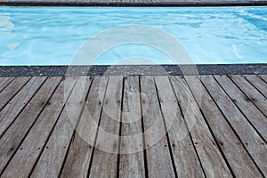 Blue swimming pool summer vacation and wooden deck