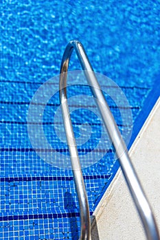 Blue swimming pool water rippled detail
