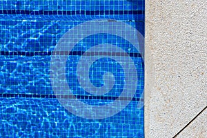 Blue swimming pool water rippled detail