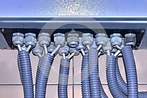Blue switchboard and branches of electrical wires in the corrugation. photo