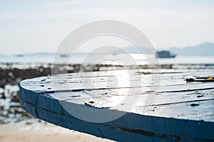 Blue table top on blurred blue sea beach against sunshine