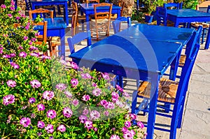 Blue tables in colorful Greek restaurant, Greece