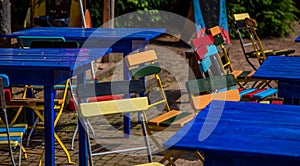 Blue tables with colorfull chairs photo