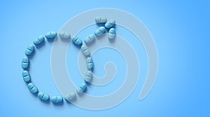 Blue tablets arranged in shape of male gender symbol isolated on blue background