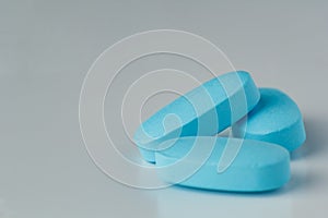 blue tablets on a light background, vitamins and medicines