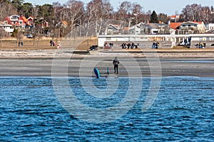 Blue Tabou foiling board on a beach..