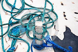 Blue tackle on rustic white boat abstract photo. Rustic blue rope on white wood. White yacht exterior detail