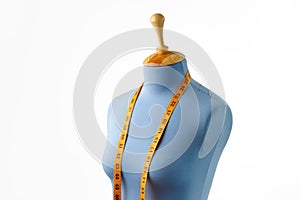 Blue tailor dummy with measuring tape isolated on white.