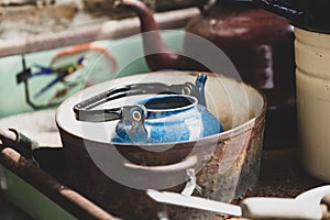 Blue teapot in rusty stewpan