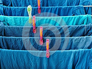 Blue Teeshirts Drying on Rack