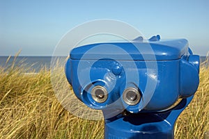 Blue telescope on the beach