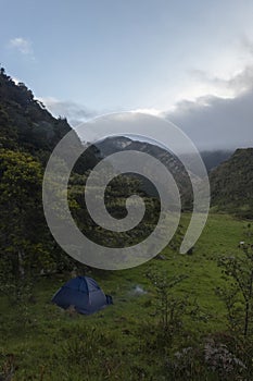 Blue tend camping near to a forest mountain in middle of colombian andean mountains valley