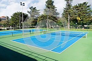 Blue Tennis court. Outdoor sunny day. Sport landscape