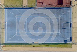 Blue tennis courts with artificial turf. Shooting from the height of bird flight. Minifootball field with a gate. View from the