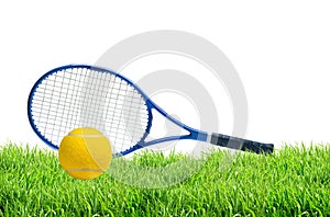 Blue tennis racket and yellow tennis ball on green grass isolate