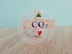 Blue text CO2 on brick block, cubes with arrow up down, concept of carbon reduction, Limiting global warming and mitigating