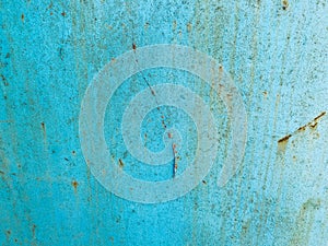 Blue texture, metal wall painted in blue paint. the background. peeling, old paint on the metal, traces of corrosion and damage.