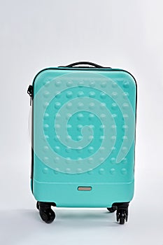 Blue textured suitcase for travel.