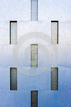 Blue Textured Wall With Vertical Glass Windows Creating Modern Geometric Pattern
