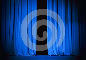 Blue theatre stage curtain slightly open photo