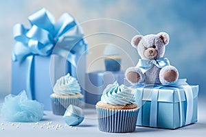 Blue theme baby boy cupcakes and baby favour gift boxes against blue background for baby shower or new born nursery greeting card
