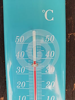 Blue thermometer showing 38 degrees photo