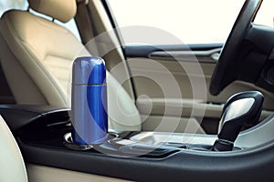 Blue thermos in holder inside of car
