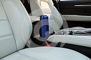 Blue thermos in holder inside of car