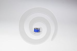 Blue thread bobbin on white background