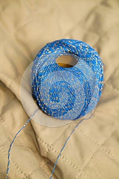 Blue thread with golden spots